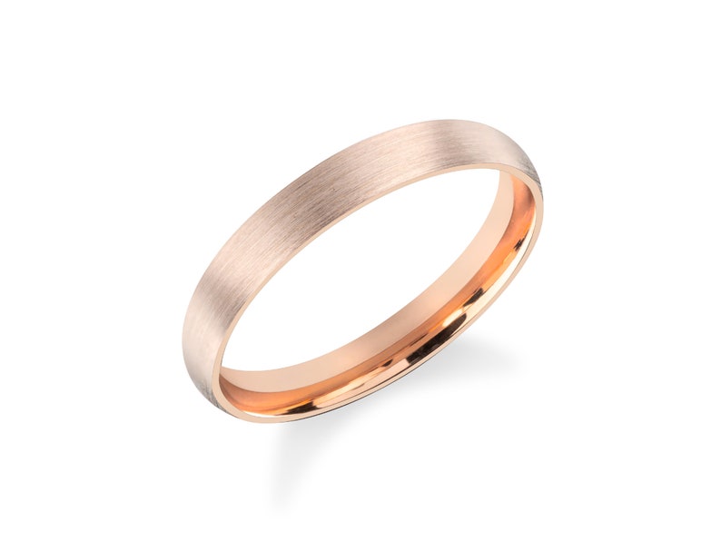 May include: A brushed rose gold wedding band with a polished inner edge.