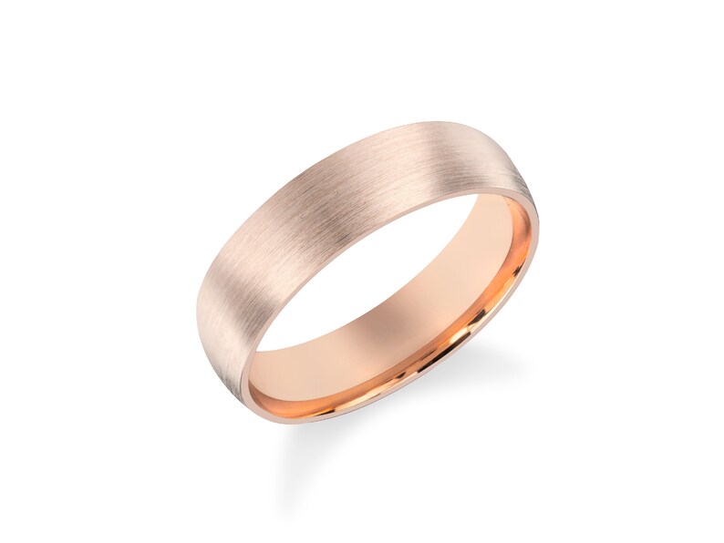 May include: A brushed rose gold wedding band with a polished inner edge.