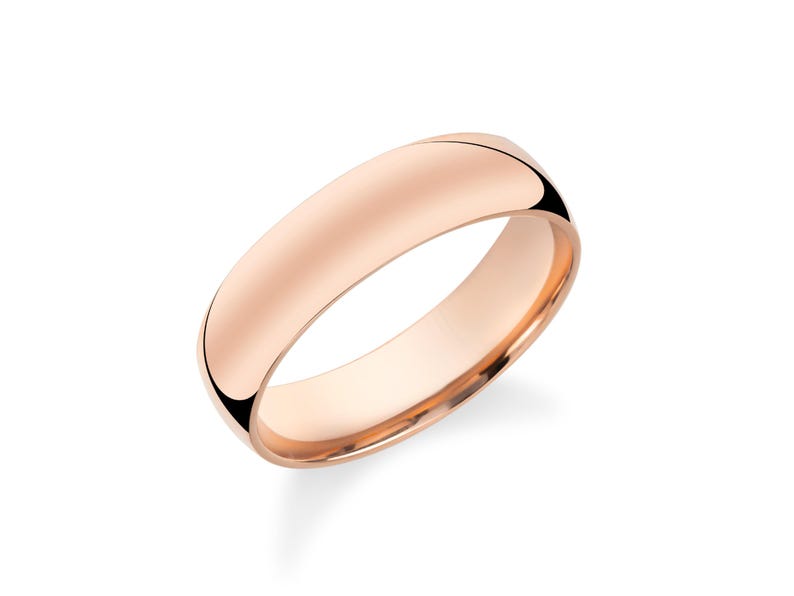 A single, shiny gold ring is shown against a white background.