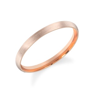 May include: A simple, brushed rose gold wedding band with a polished inner edge.