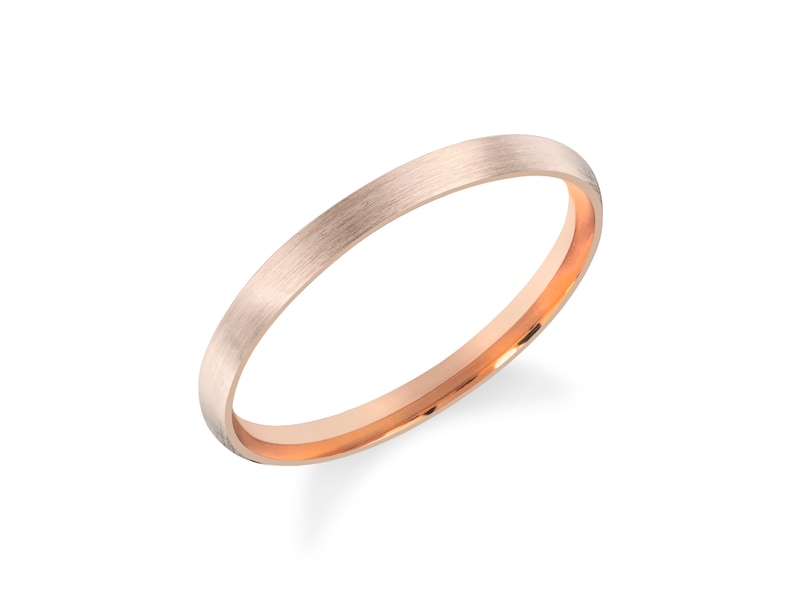 May include: A simple, brushed rose gold wedding band with a polished inner edge.