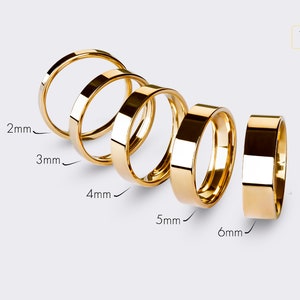 May include: Five gold rings of different widths, ranging from 2mm to 6mm, are displayed on a white background. The rings are all made of 14K gold.