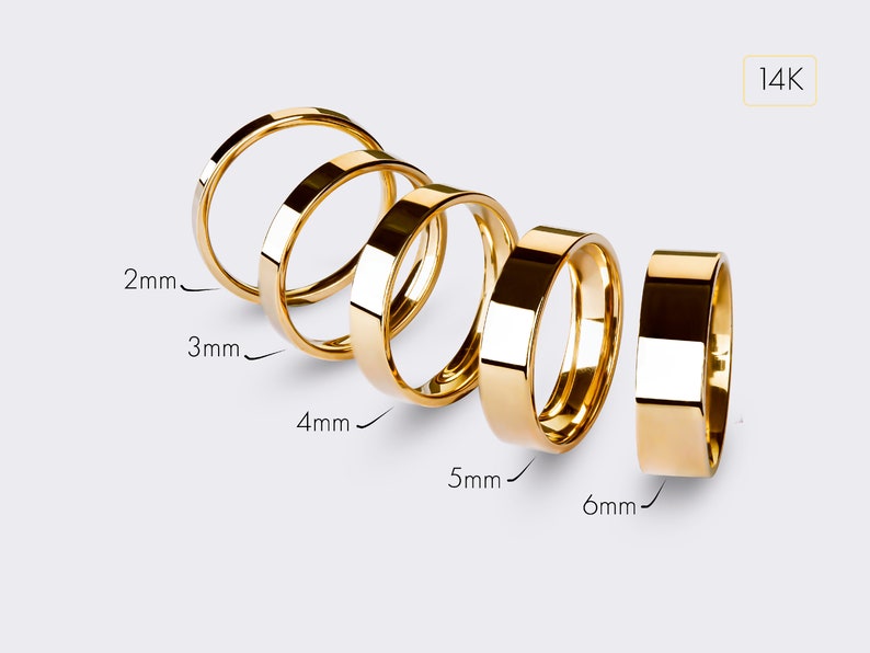 May include: Five gold rings of different widths, ranging from 2mm to 6mm, are displayed on a white background. The rings are all made of 14K gold.