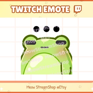 May include: Green frog emoji with a surprised expression and three black dots above its head. The frog is outlined in black and has a light green body with a darker green head. The background is a white grid.