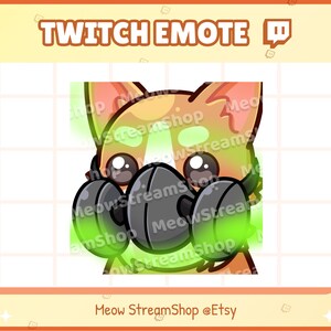 May include: A cartoon fox wearing a black gas mask with green glowing accents. The fox is looking at the viewer with a worried expression. The text "Twitch Emote" and "Meow StreamShop @Etsy" is visible in the image.