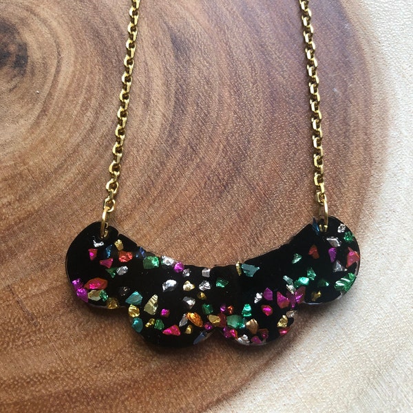 Handmade resin black bib necklace with encased multicolour glass. Bespoke, statement, quirky jewellery for her.