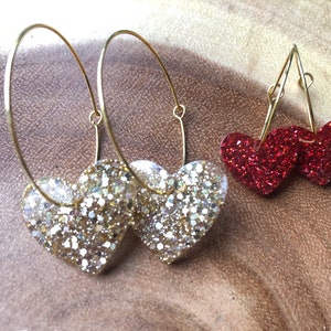Handmade resin glittery dangle heart earrings on gold plated hoops. Choose from red or golden.Cute gift for her