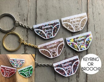Porte-clés ou broche pour pantalons à paillettes en résine fait main