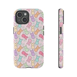 May include: A pink phone case with a pattern of pastel-coloured Peeps and white flowers.