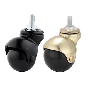 May include: Two swivel casters, one black and one gold, with a metal stem and a black rubber wheel.