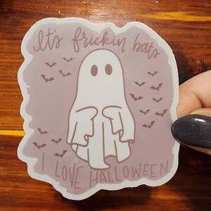 May include: A pink and white sticker with a ghost and bats. The text reads "It's frickin' bats I love Halloween."
