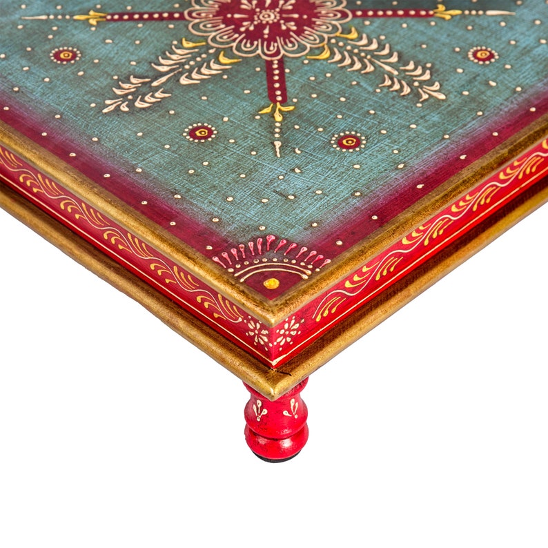 May include: A hand-painted wooden table with a blue and red top and gold trim. The table has four red legs with a turned design.