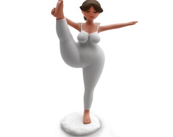 May include: White ceramic figurine of a woman in a yoga pose with one leg raised. The figurine is standing on a white base.