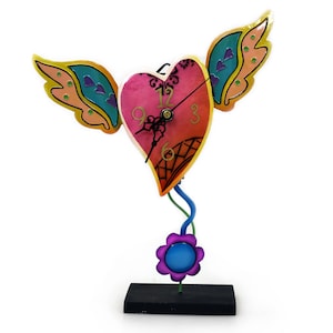 Clock heart with wings, swinging pendulum