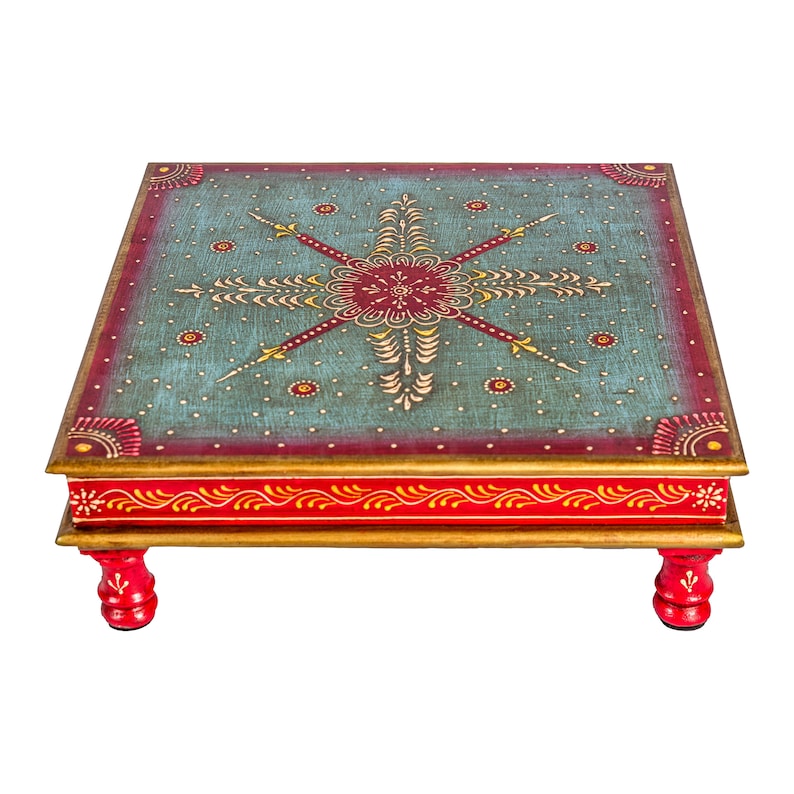 May include: A square wooden table with four legs, painted in red and gold with a blue and red floral design on the top.