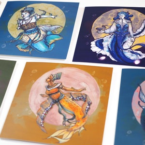 May include: A selection of square art prints displaying mermaid illustrations. Each print presents a distinct mermaid design with vivid colours, set against a full moon backdrop. The mermaids are shown in diverse poses and styles, creating a whimsical and artistic collection.