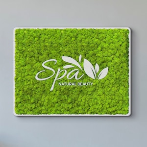 May include: A rectangular wall art piece featuring a vibrant green preserved moss texture. Centered on the moss is a white cutout logo with the script text "Spa" and the words "NATURAL BEAUTY" in a clean, sans-serif font, framed in white.