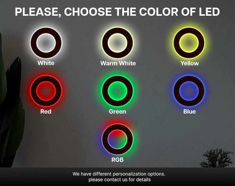 May include: A display showing seven circular wooden rings with LED lighting options. The text reads PLEASE, CHOOSE THE COLOUR OF LED, with labels for White, Warm White, Yellow, Red, Green, Blue, and RGB. A footer states We have different personalisation options.