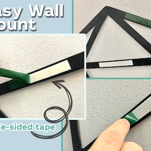 May include: A black geometric wall mount featuring pre-applied double-sided adhesive strips. The product includes text that reads Easy Wall Mount and double-sided tape, showing the installation process with green peel-off backing strips.