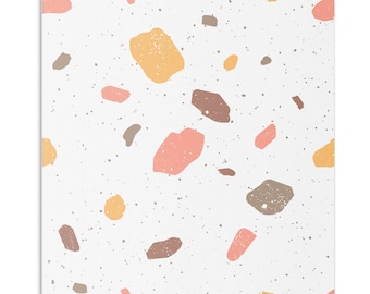 May include: A square wall art piece featuring a white background with a scattered terrazzo pattern. The design consists of irregular shapes in shades of soft pink, muted orange, and brownish-gray, accented by tiny dark gray speckles throughout.