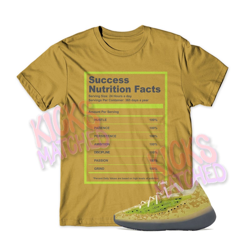 May include: A mustard yellow t-shirt with a graphic of a nutrition facts label that reads "Success Nutrition Facts". The label lists the ingredients for success as hustle, patience, persistence, ambition, discipline, passion, and grind. The t-shirt is paired with a pair of green and black sneakers.