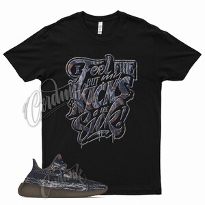 May include: Black t-shirt with a graphic print that says "I feel fine but my kicks are sick!"  A pair of brown and grey sneakers are in the bottom left corner of the image.