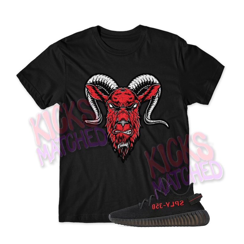 May include: Black t-shirt with a red ram head graphic and a pair of black Yeezy 350 Boost sneakers with red accents. The text "YZY-350" is printed on the side of the shoe.