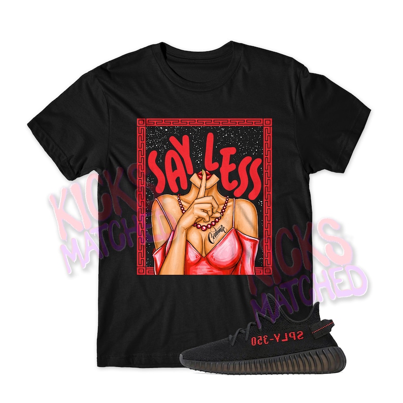 May include: Black t-shirt with a red graphic of a woman with her finger over her lips and the text "SAY LESS" in red. The t-shirt is paired with black and red Yeezy sneakers.