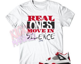 Camiseta blanca "REAL ONES" para combinar con Jordan 4 Fire Red de Kicks Matched