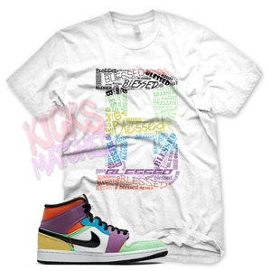 White &quot; BLESSED &quot; T Shirt to match Jordan 1 WMNS Lightbulb Multi Color Playground by Kicks Matched