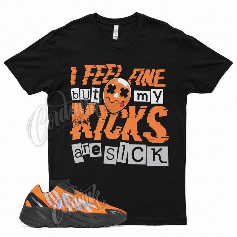 May include: Black t-shirt with orange text that reads "I feel fine but my kicks are sick". A cartoon orange balloon with a face is in the text. A pair of black and orange sneakers are in the foreground.