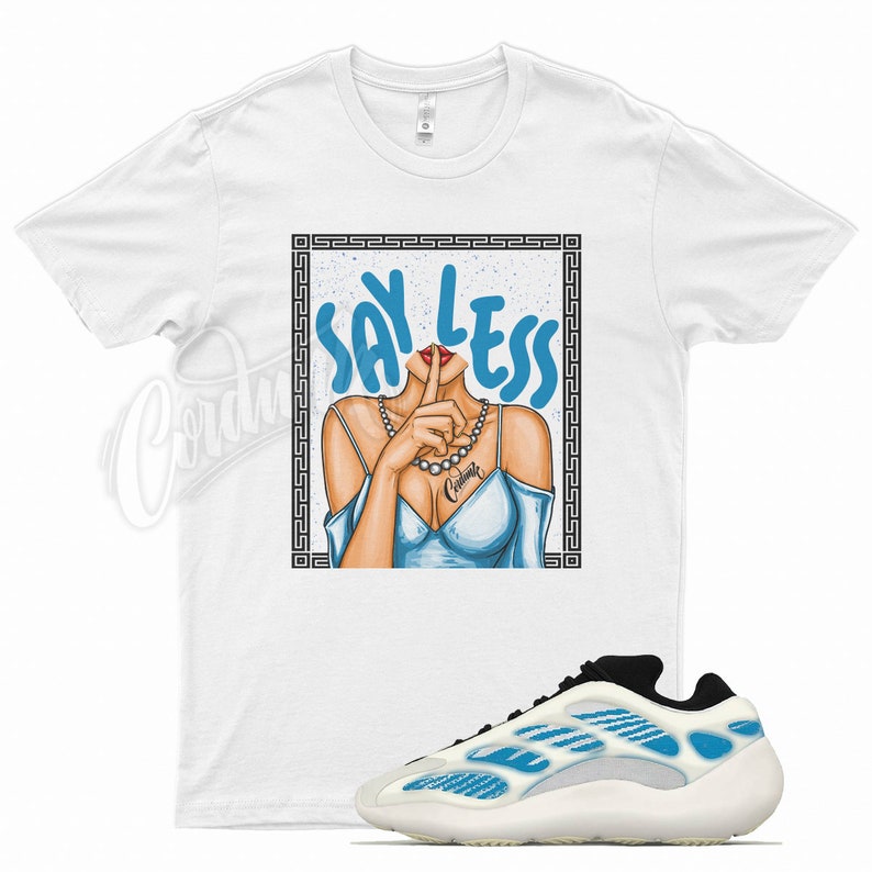 May include: White t-shirt with a graphic of a woman with her finger to her lips and the text "Say Less" in blue.  A pair of white and blue sneakers with a black accent.