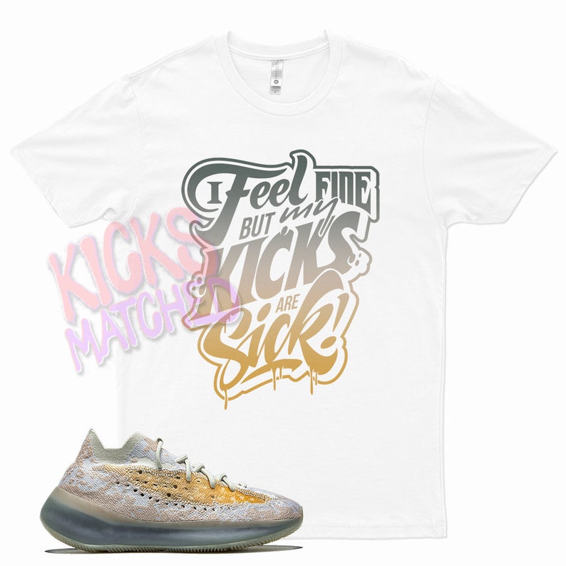 K&ouml;nnte beinhalten: Wei&szlig;es T-Shirt mit einem grafischen Aufdruck, auf dem "I Feel Fine But My Kicks Are Sick!" steht. Ein Paar hellbraune und beigefarbene Sneaker mit wei&szlig;er Sohle.