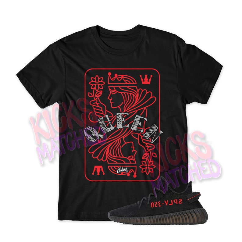 May include: Black t-shirt with a red queen of hearts playing card graphic. The shirt is paired with black and red sneakers with the text "Yeezy-350" on the side.