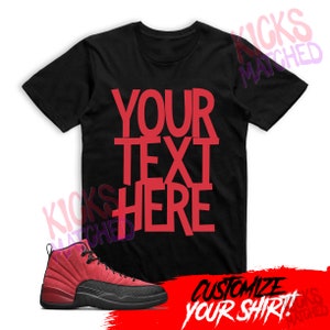 May include: Black t-shirt with red text that says "YOUR TEXT HERE" and a pair of red and black sneakers. The text "CUSTOMIZE YOUR SHIRT!" is written in red on a white background.