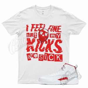 May include: White t-shirt with red text that reads "I feel fine but my kicks are sick". A red and white basketball shoe is shown below the t-shirt.