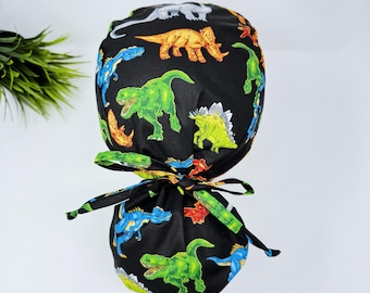 Dinosaur Ponytail scrub cap for women. Dino Surgical hat with satin lined option by Paradise Caps.