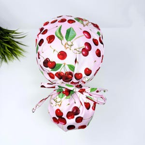 Cherries Ponytail scrub cap with satin lined. Pink surgical cap for women by Paradise Caps.