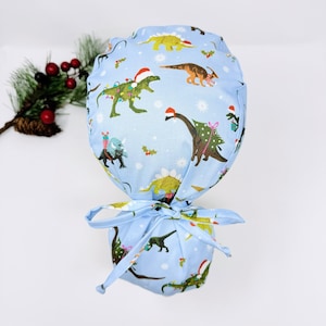 Christmas Ponytail scrub cap with Satin Lined. Dinosaurs scrub hats for women by Paradise Caps.