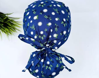 Ponytail scrub cap for women. Navy Daisy surgical hat for women with satin lined option by Paradise Caps.