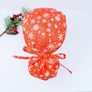 Christmas Ponytail scrub cap with Satin Lined. Snowflakes scrub hats for women by Paradise Caps.