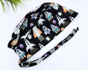 Men's surgical scrub cap. Black Space Rocket Print skull tie-back style scrub hat by Paradise Caps.