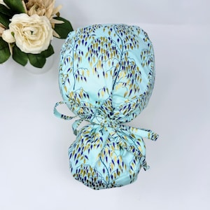 Floral Ponytail scrub cap by ParadiseCaps. Light blue surgical scrub hat for women. Satin lined option surgical cap. Garden plants - print.