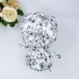 Floral ponytail scrub cap with satin lined option. Summer scrub cap with ponytail holder for women by Paradise Caps.