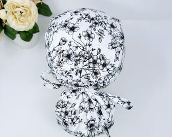 Floral ponytail scrub cap with satin lined option. Summer scrub cap with ponytail holder for women by Paradise Caps.