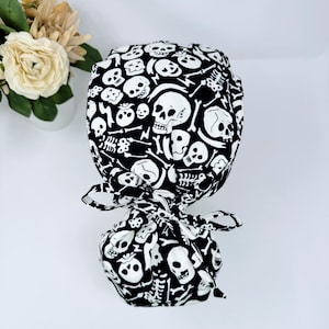 Glow Halloween Ponytail scrub cap for women. Skull Surgical hat with satin lined option by Paradise Caps.