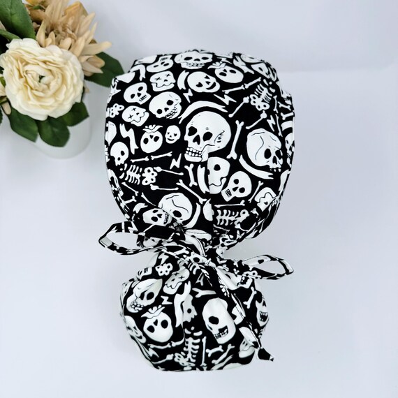 Glow Halloween Ponytail scrub cap for women. Skull Surgical hat with satin lined option by Paradise Caps.