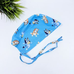 Funny Men&#39;s surgical cap. Blue skull tie-back style scrub cap by Paradise Caps.