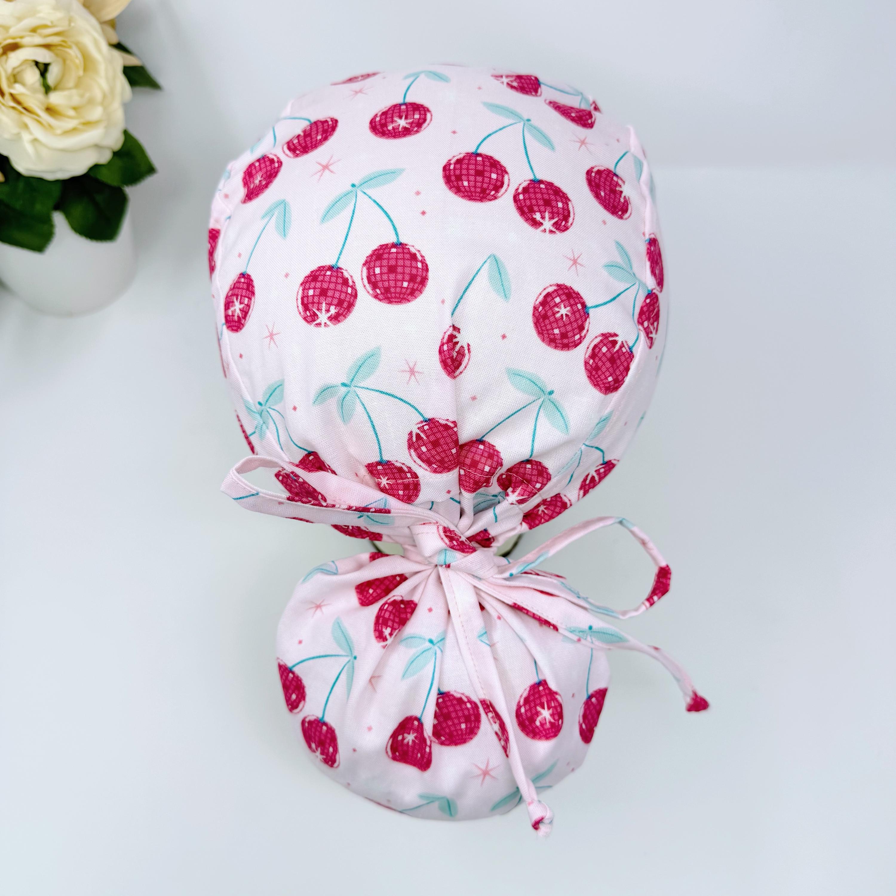 Cherries Ponytail scrub cap with satin lined. Pink surgical cap for women by Paradise Caps.