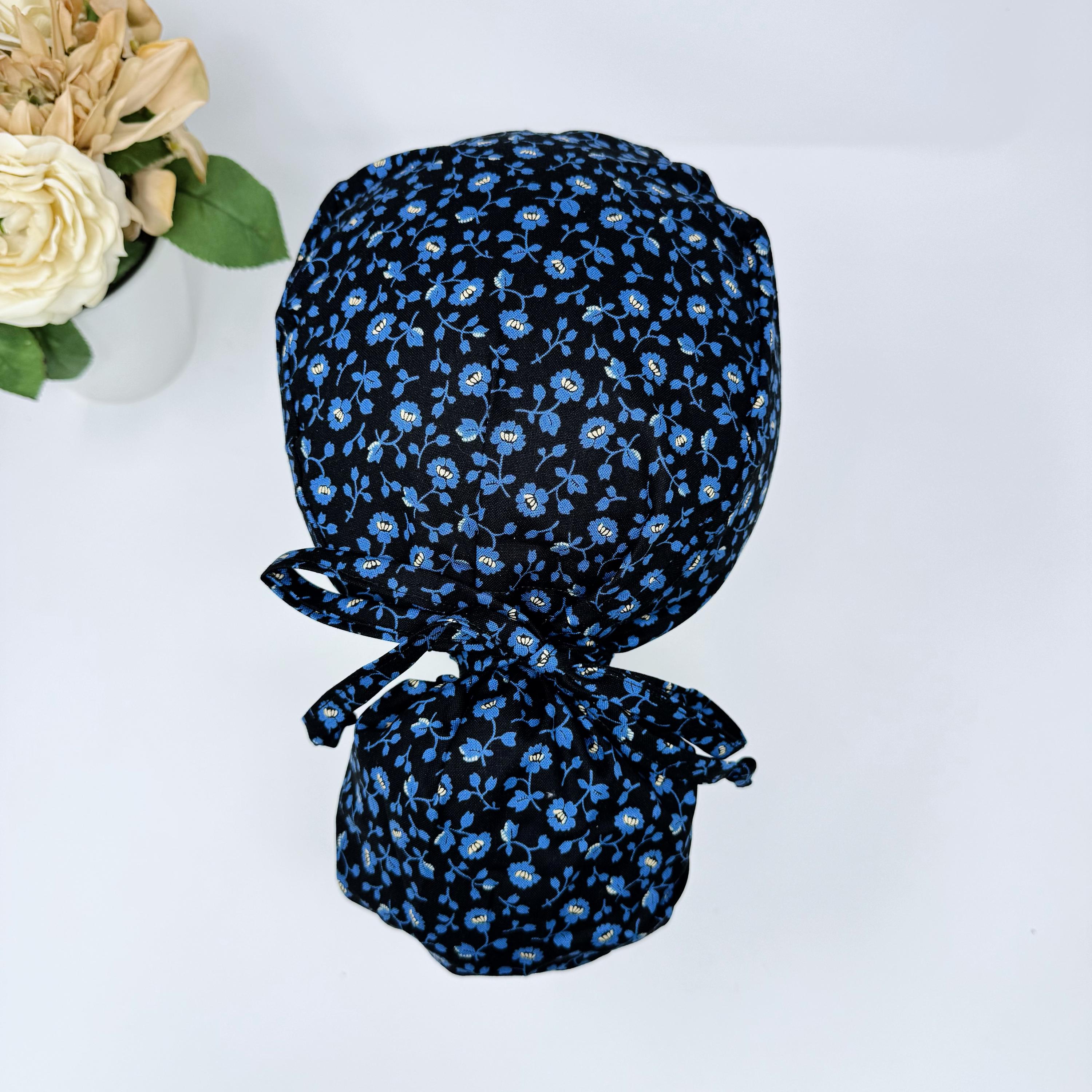 Ponytail scrub hat for women. Blue Flower Surgical cap. Satin Lined option surgical cap with ponytail by ParadiseCaps. Floral on black.